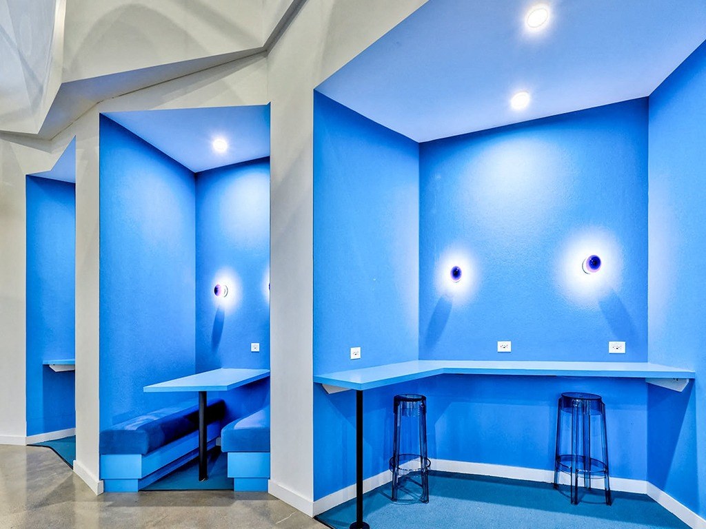 a room with blue walls and a bar with stools